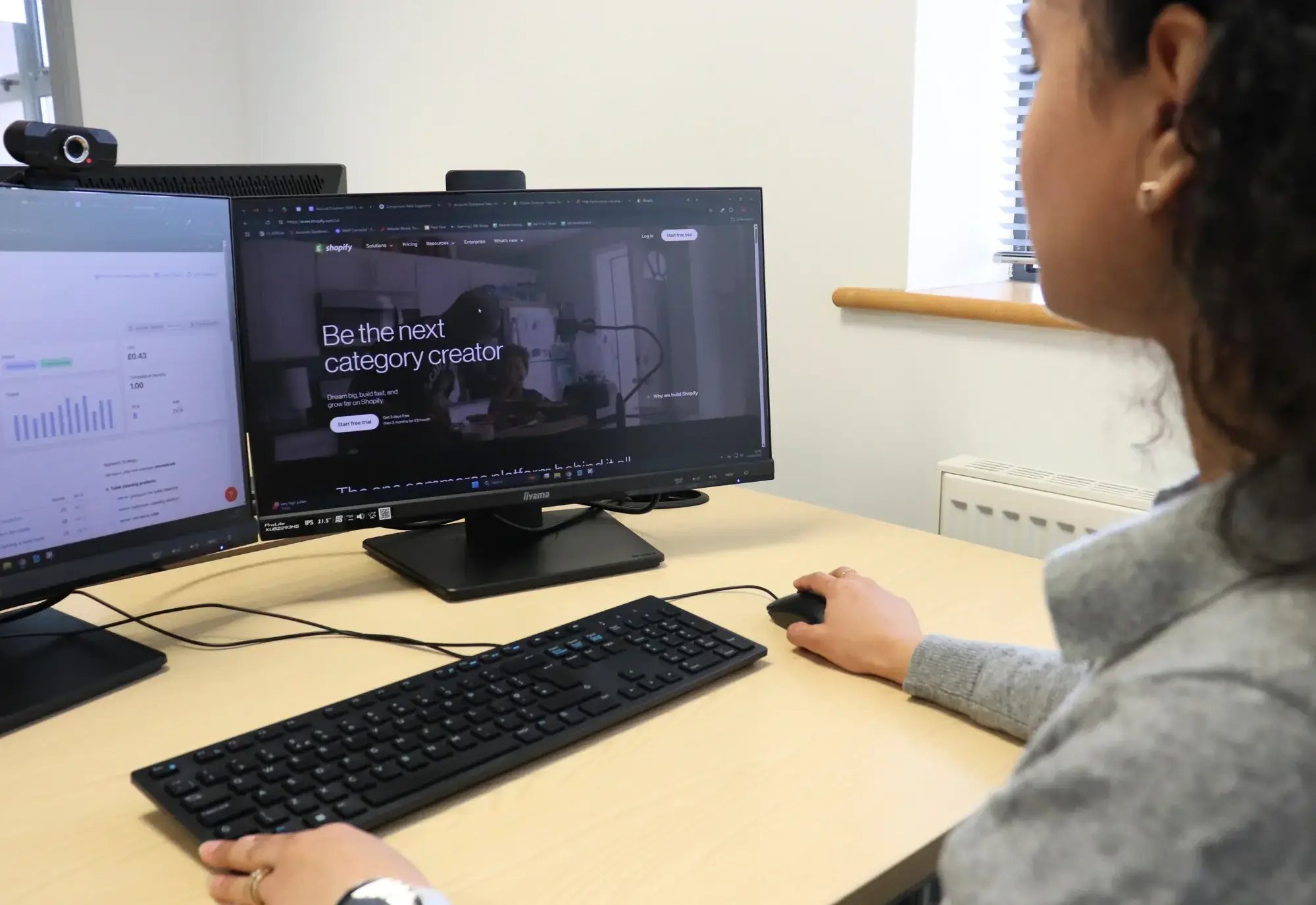 Ash working on a client's brand identity and comparing it with sales figures