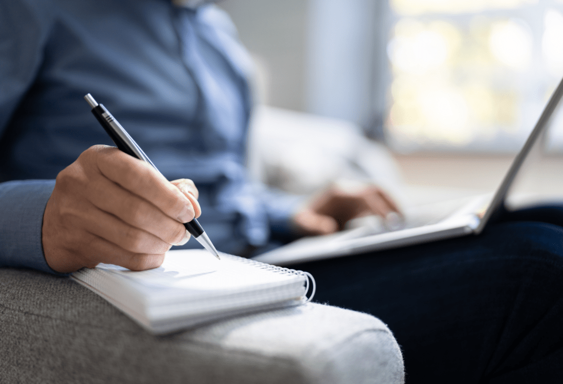 A businessman taking notes in order to build a successful content strategy