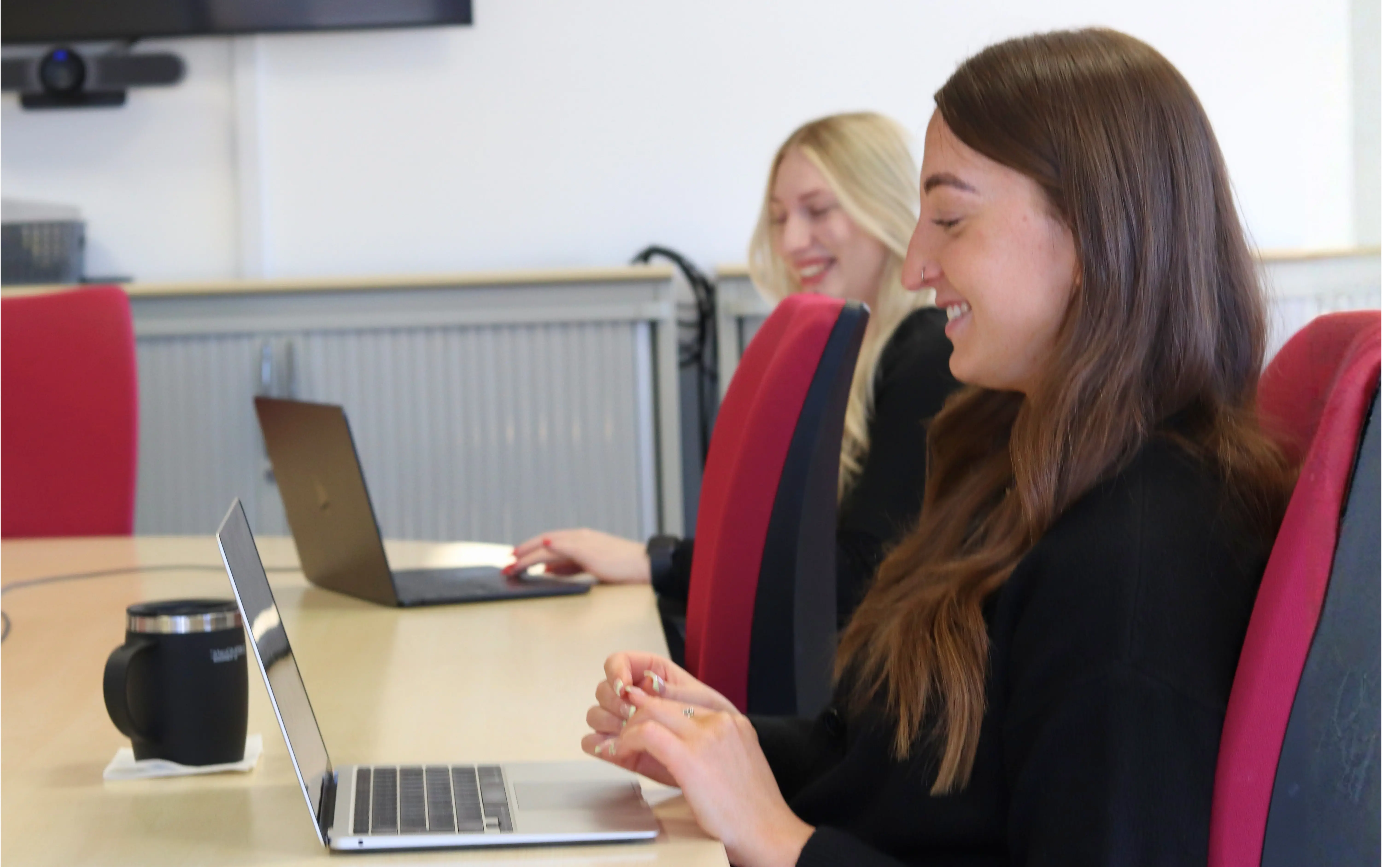 Emily and Amber from JDR smiling as they redesign the JDR website.