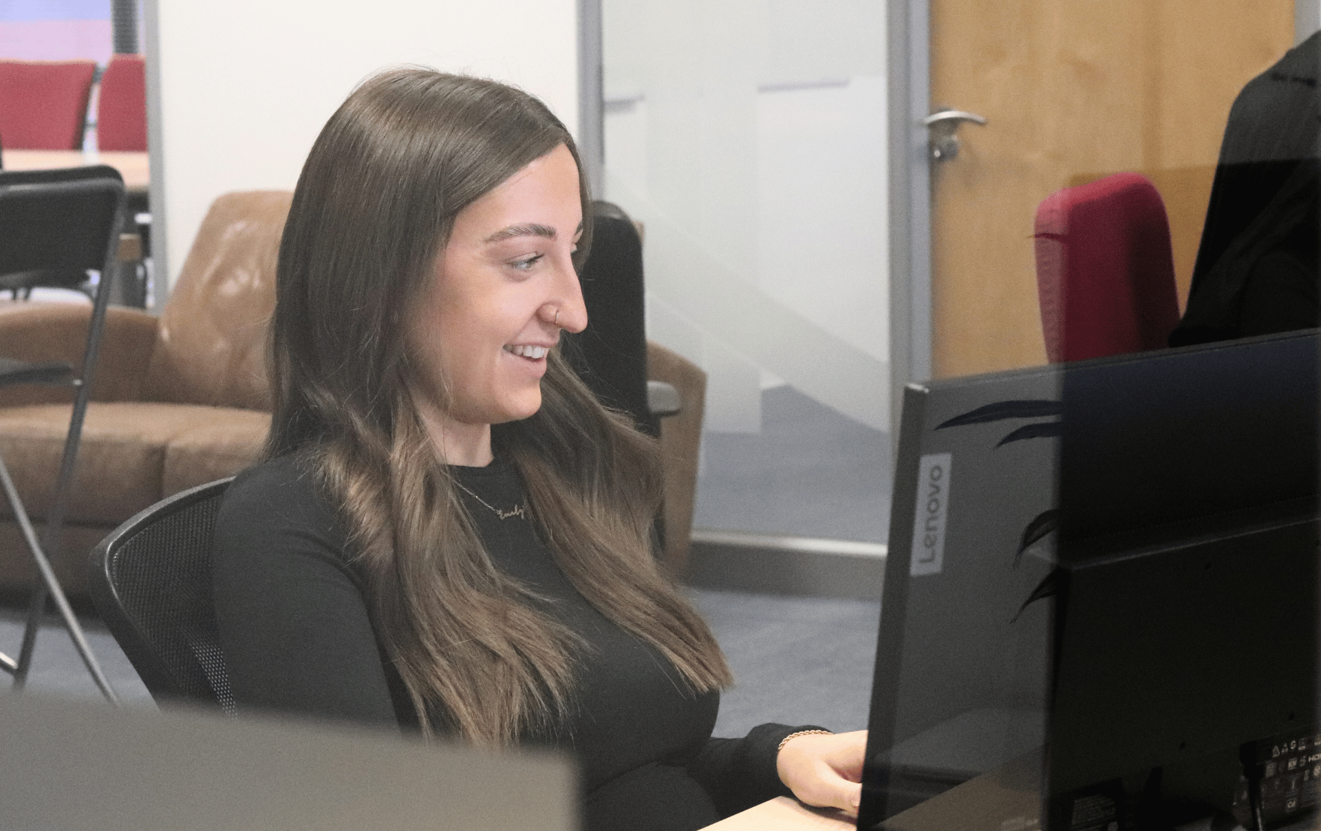 Website conversion specialist at her desk working on turning traffic into profits for clients.