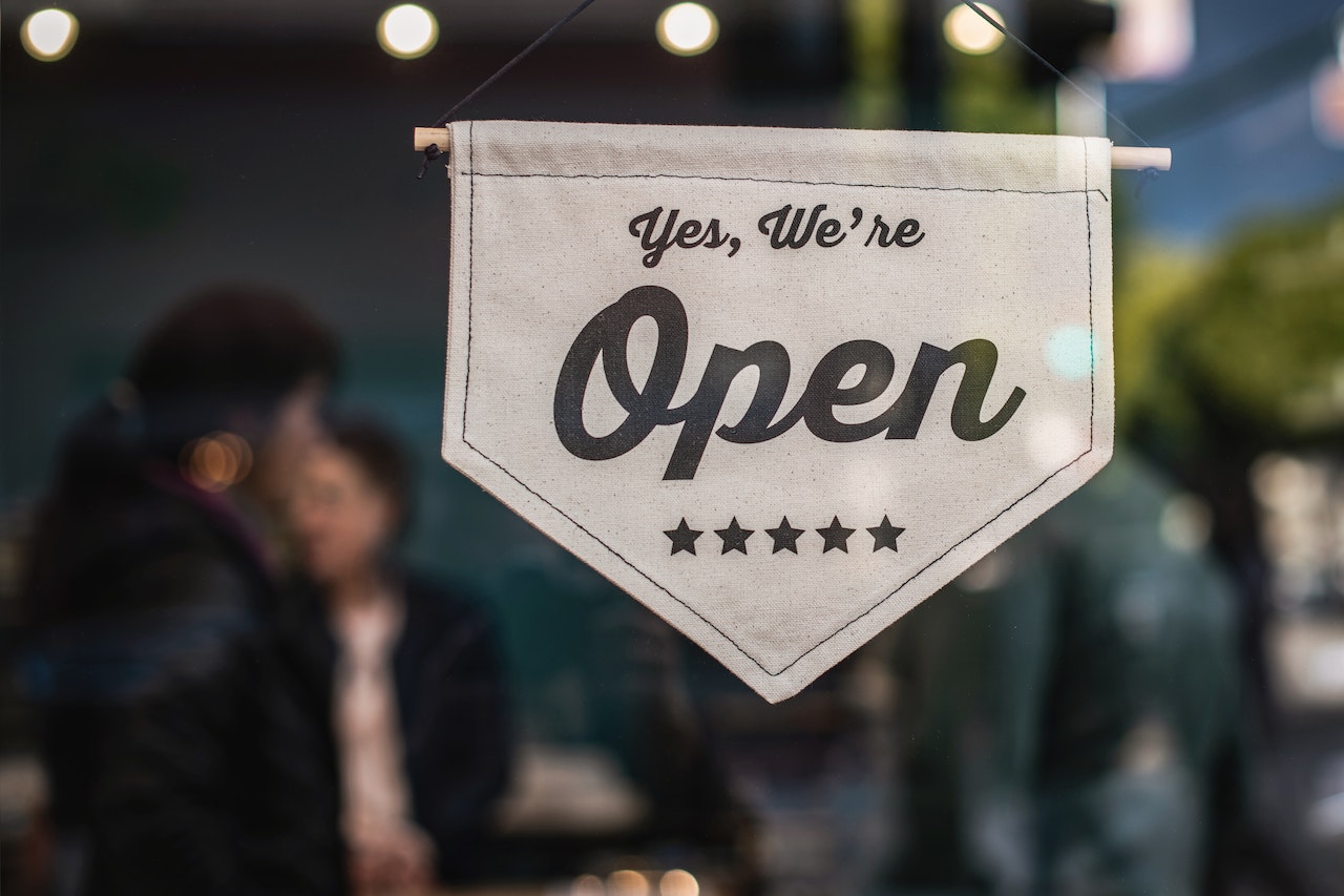 The open sign in the window of an Ecommerce store that has downloaded JDR Group's free guide on 65 Ways To Increase Ecommerce Sales, to improve their sales strategy