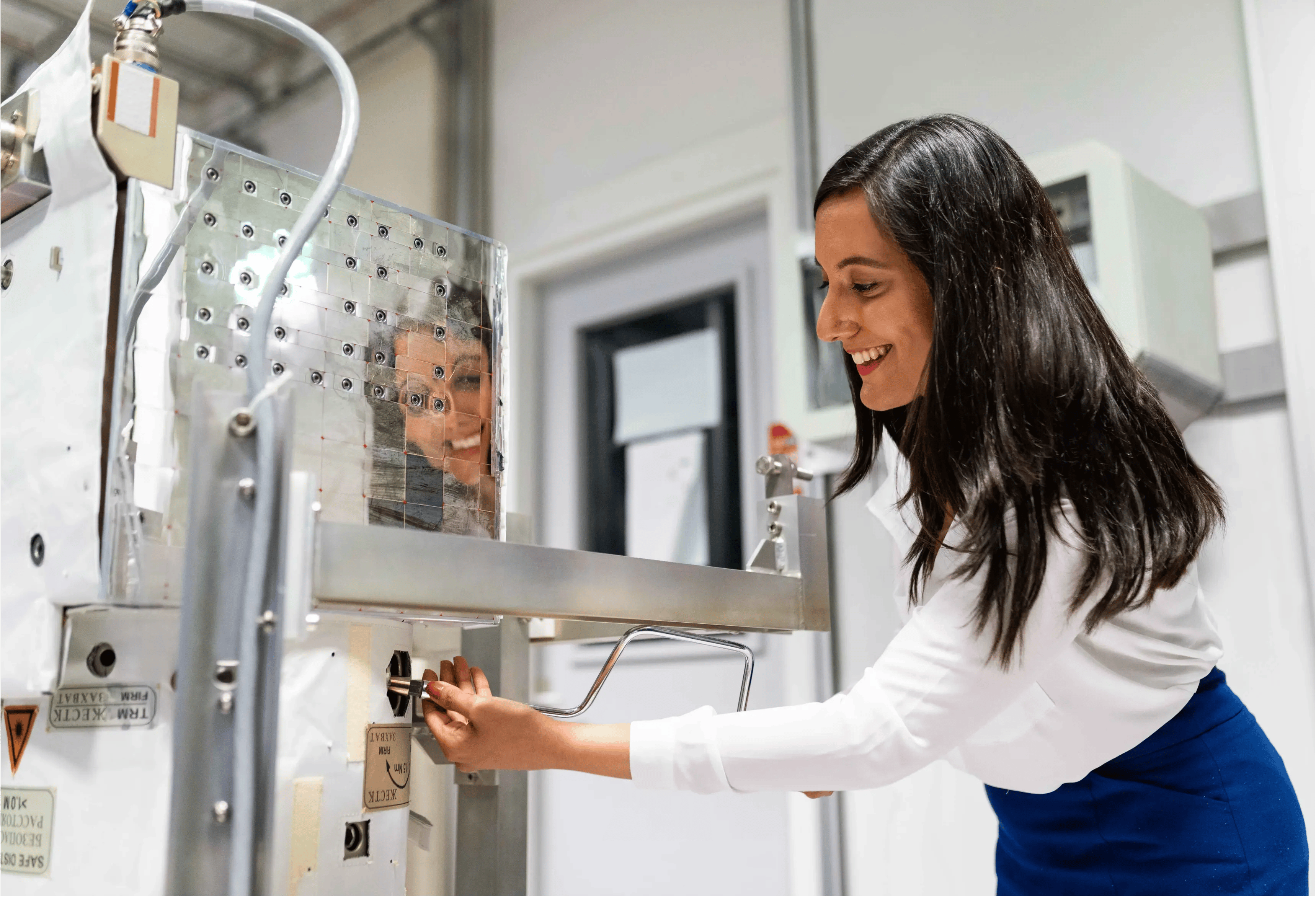 Female engineer fixing a machine.