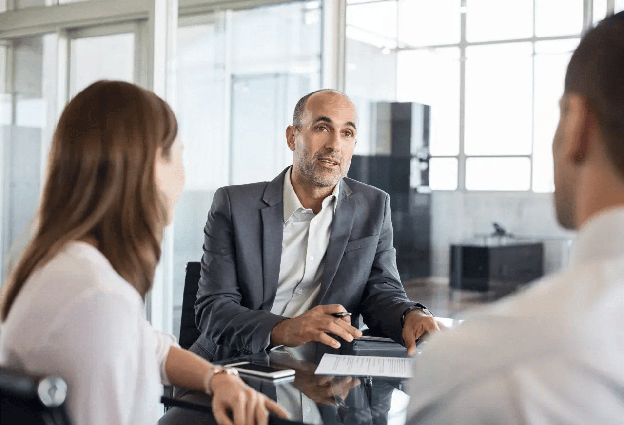 A financial advisor speaks to a couple as he explains what's the next best move is when it comes to their investments.