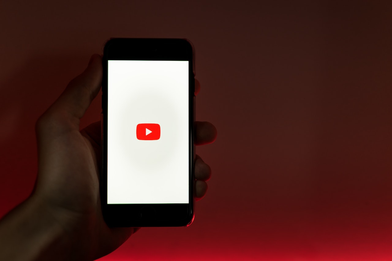 A man holding up his phone with Youtube open, ready to film a Youtube Shorts video with the new Narration Tool