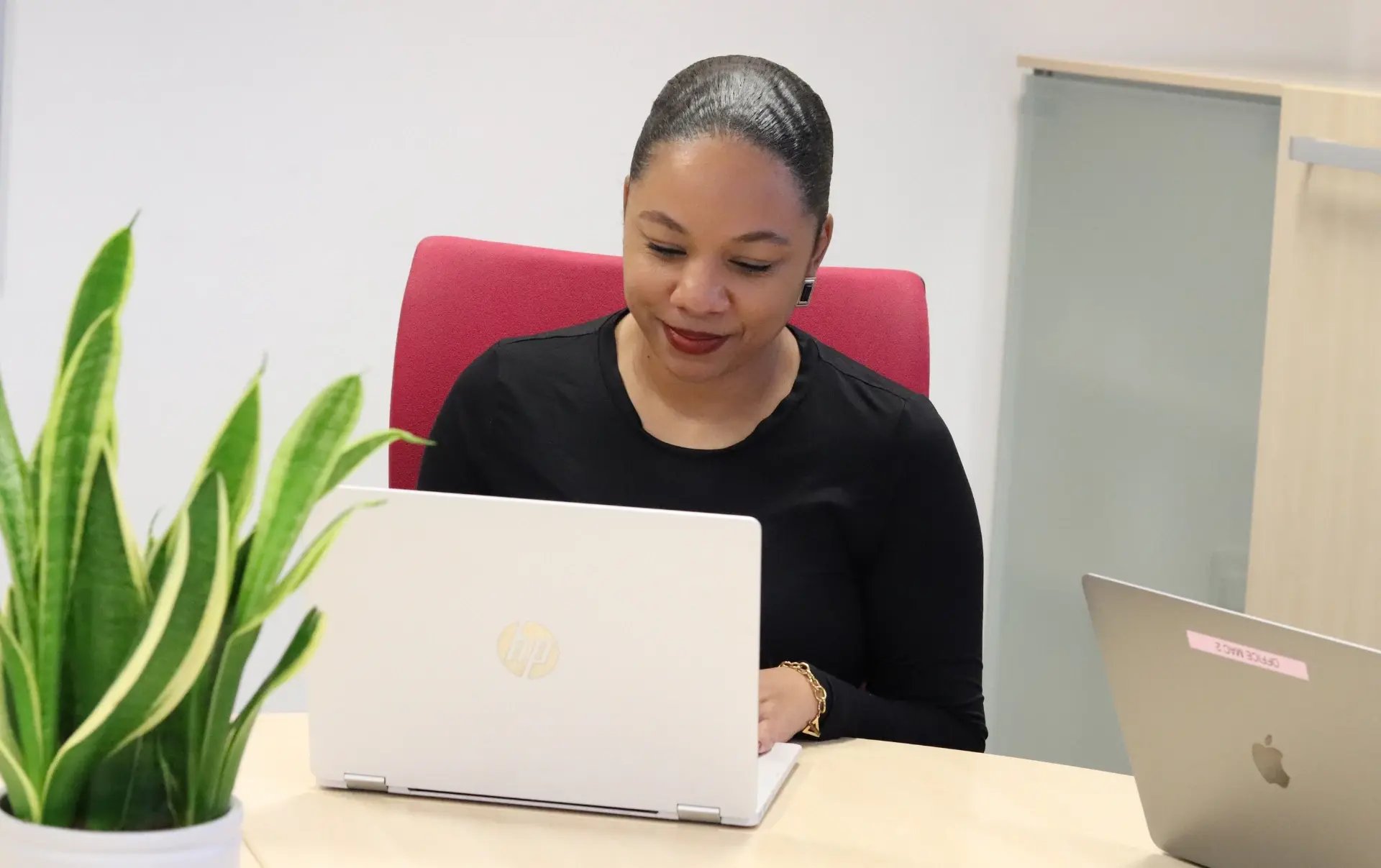 Kerry reviewing online discussions and search insights on her laptop while planning how Reddit can support a structured marketing strategy.