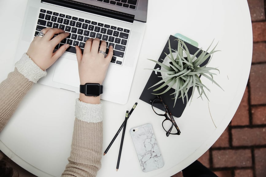 Women typing on her laptop creating a digital marketing strategy for manufacturers