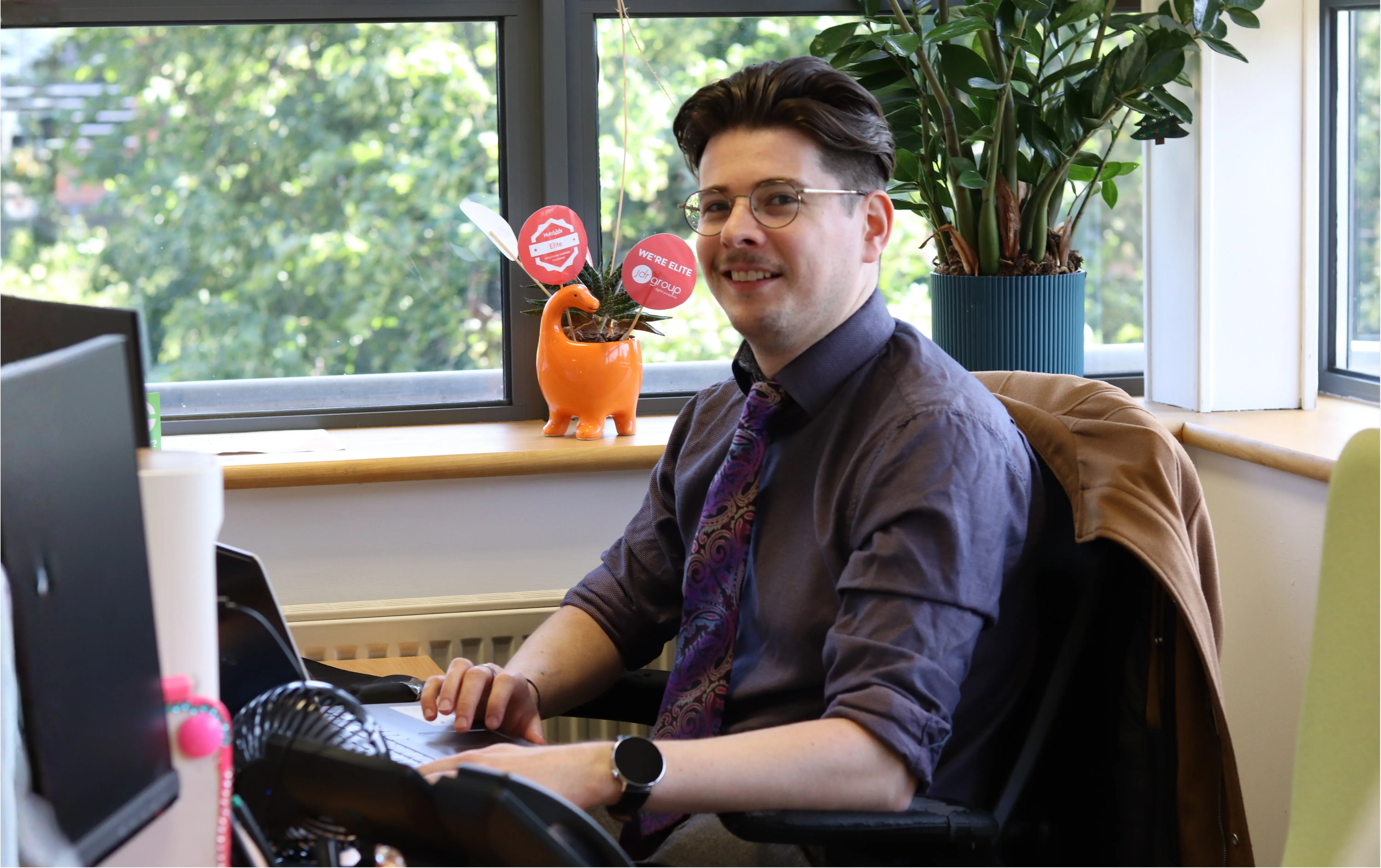 John from JDR Group working at his desk, representing how SMEs can build visibility and create demand when their business isn’t widely known yet.