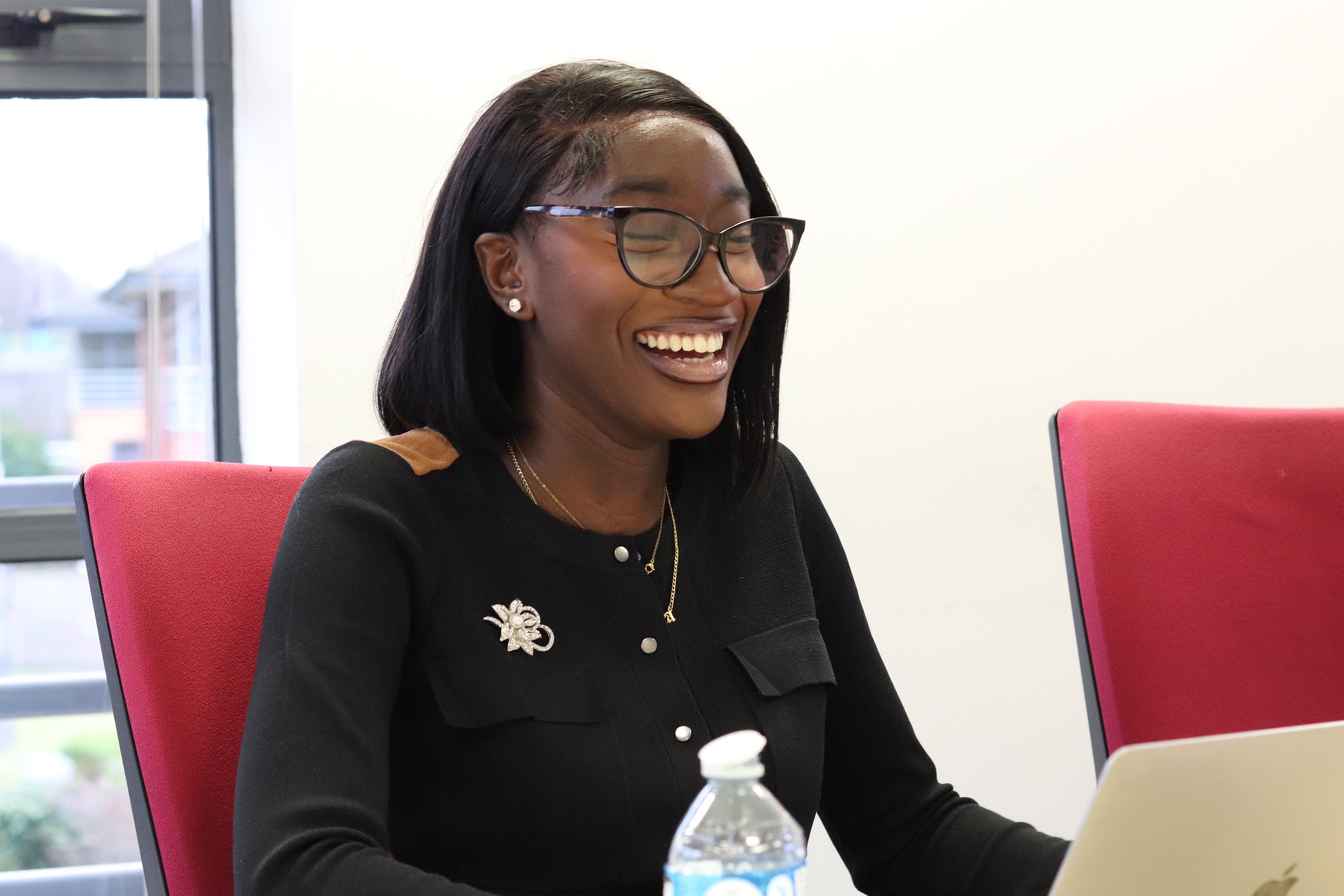 Chelsea sitting in a content meeting and laughing.