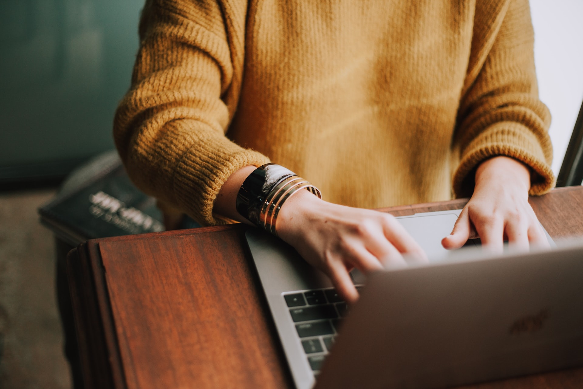 A businesswoman sitting at her laptop, creating a sales strategy using inbound marketing techniques to help grow her business