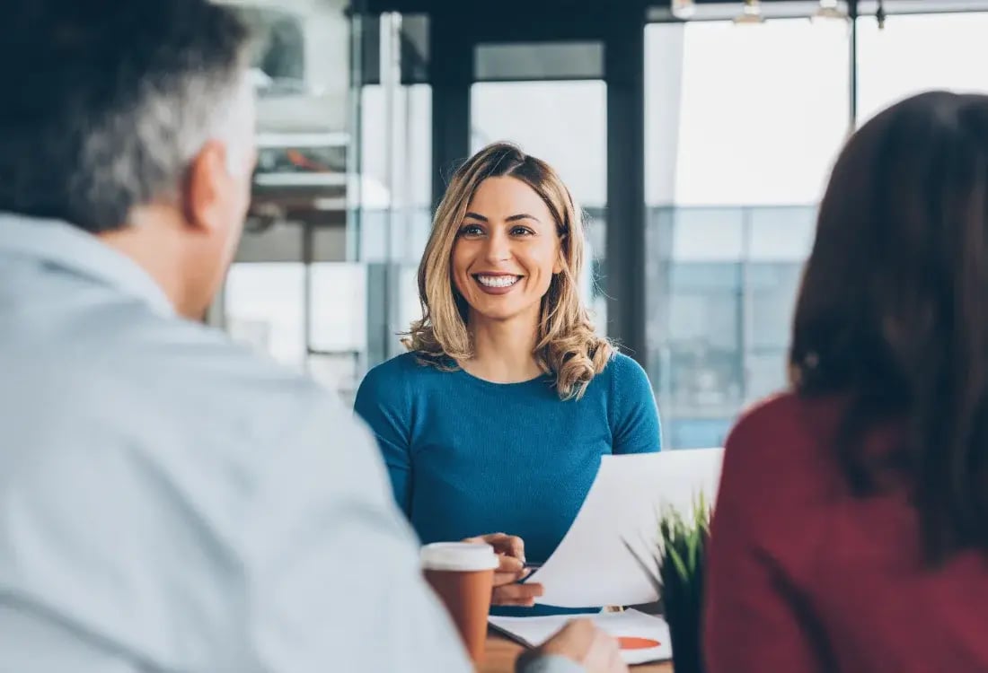 Insurance broker smiling as she closes a deal.