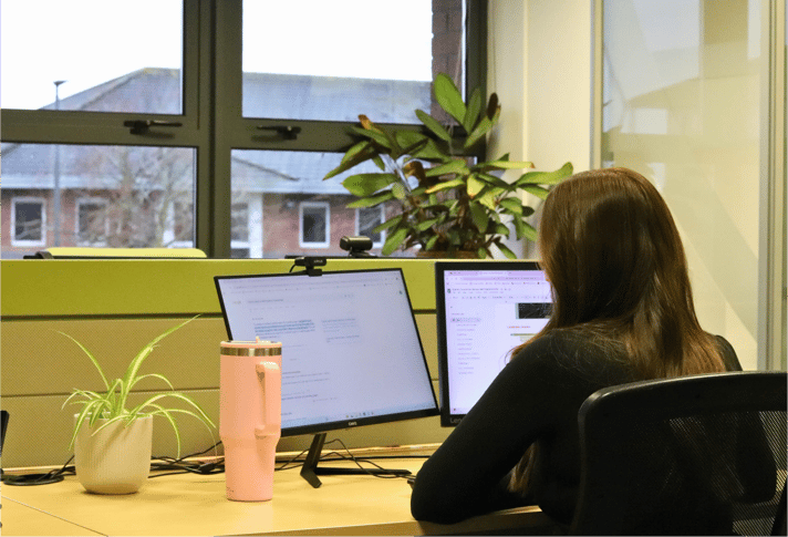 Emily from JDR working securely at a computer, representing JDR Group’s Cyber Essentials certification.