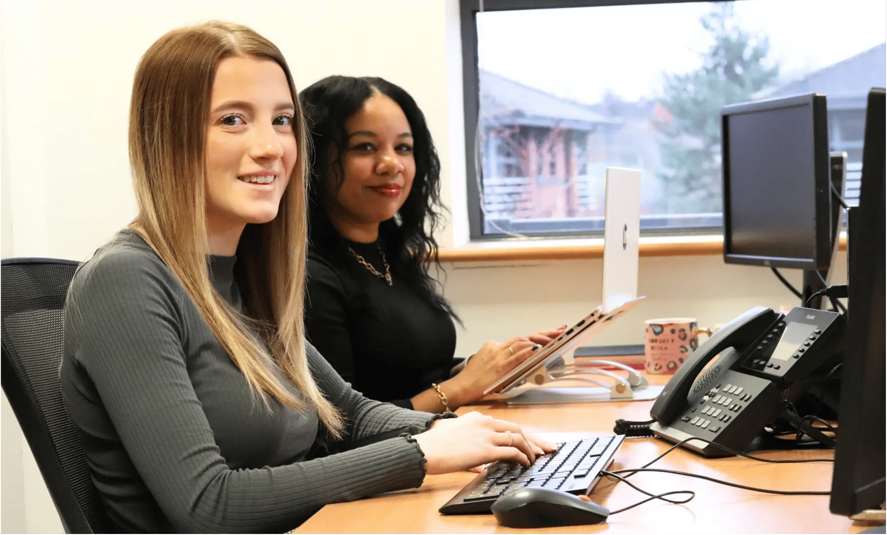 Kerry and Ellie writing social content for a law firm
