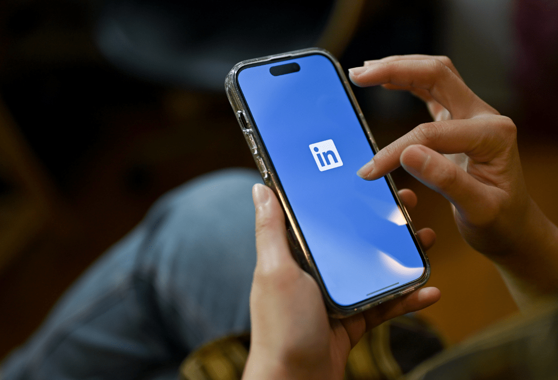 A business owner opening up their LinkedIn app after learning about the platform's update on the removal of inactive accounts and wondering how best to navigate these changes.