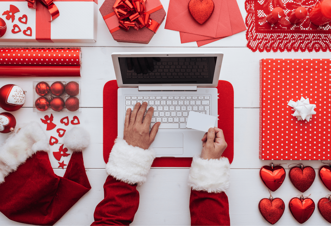 A BC2 Retail business owner creating a social media promotion on their laptop as part of their holiday marketing strategy to ensure a more profitable Christmas season.