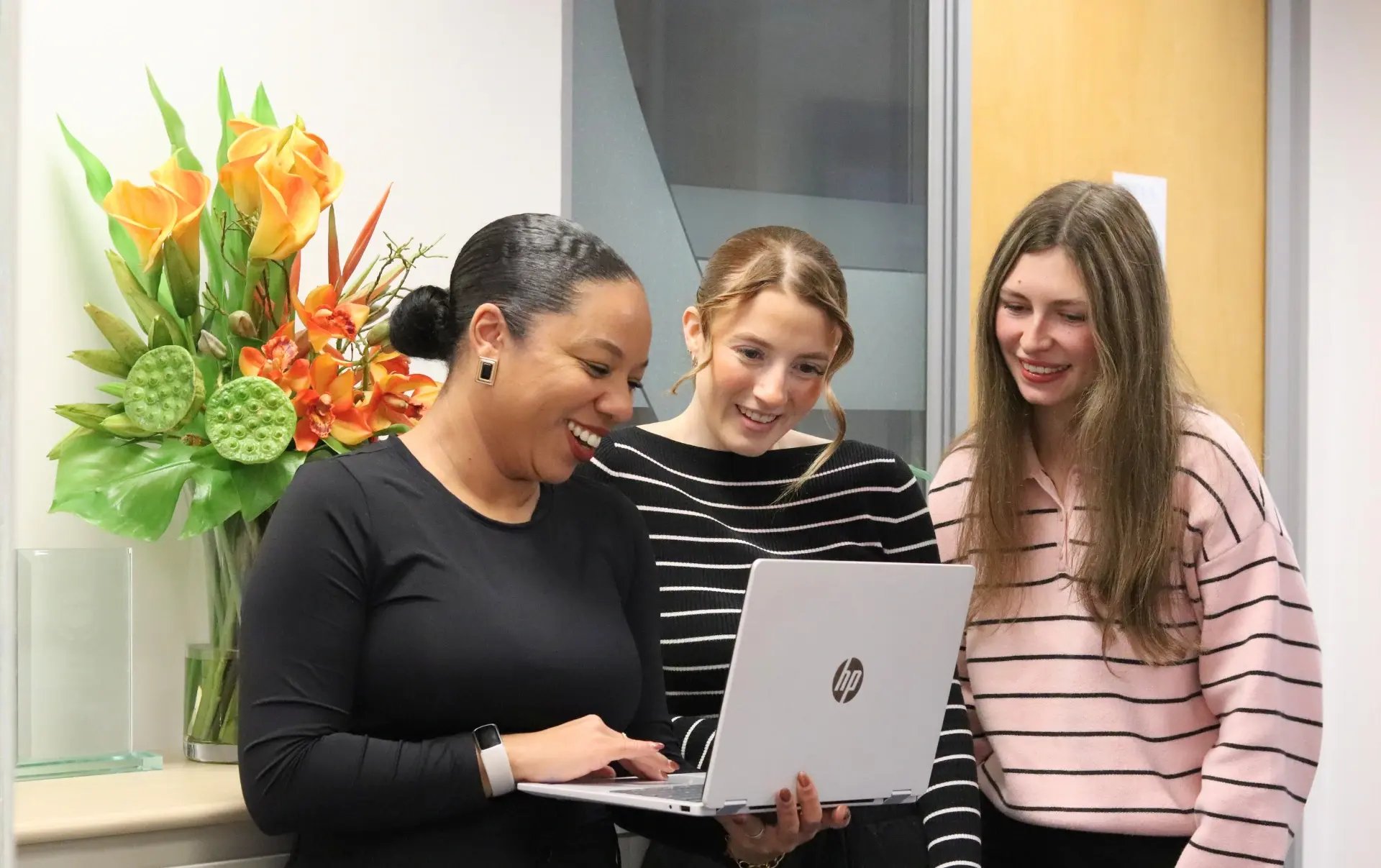 Kerry, Ellie and Sophie reviewing Threads ad performance together on a laptop as part of Meta’s expanding advertising strategy.