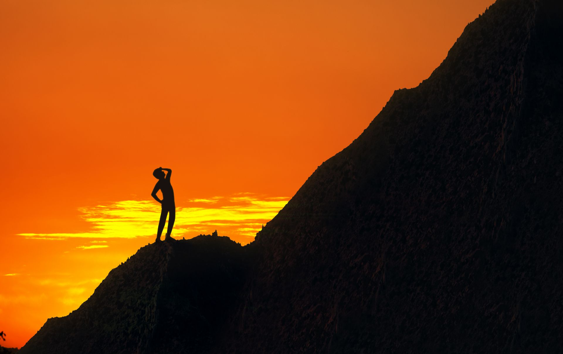 A business owner of an SME standing at the foot of a mountain looking up at the challenge he is going to have to overcome to climb it just like the challenges in his business with inbound marketing. 