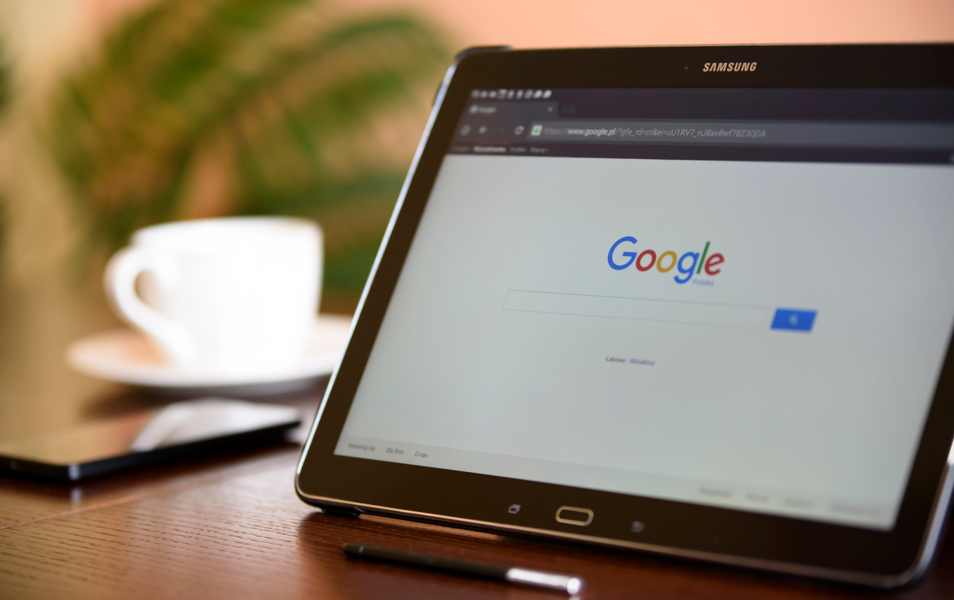 Black Samsung Tablet which is on the Google Search page looking whether they should hire someone to manage their ads.