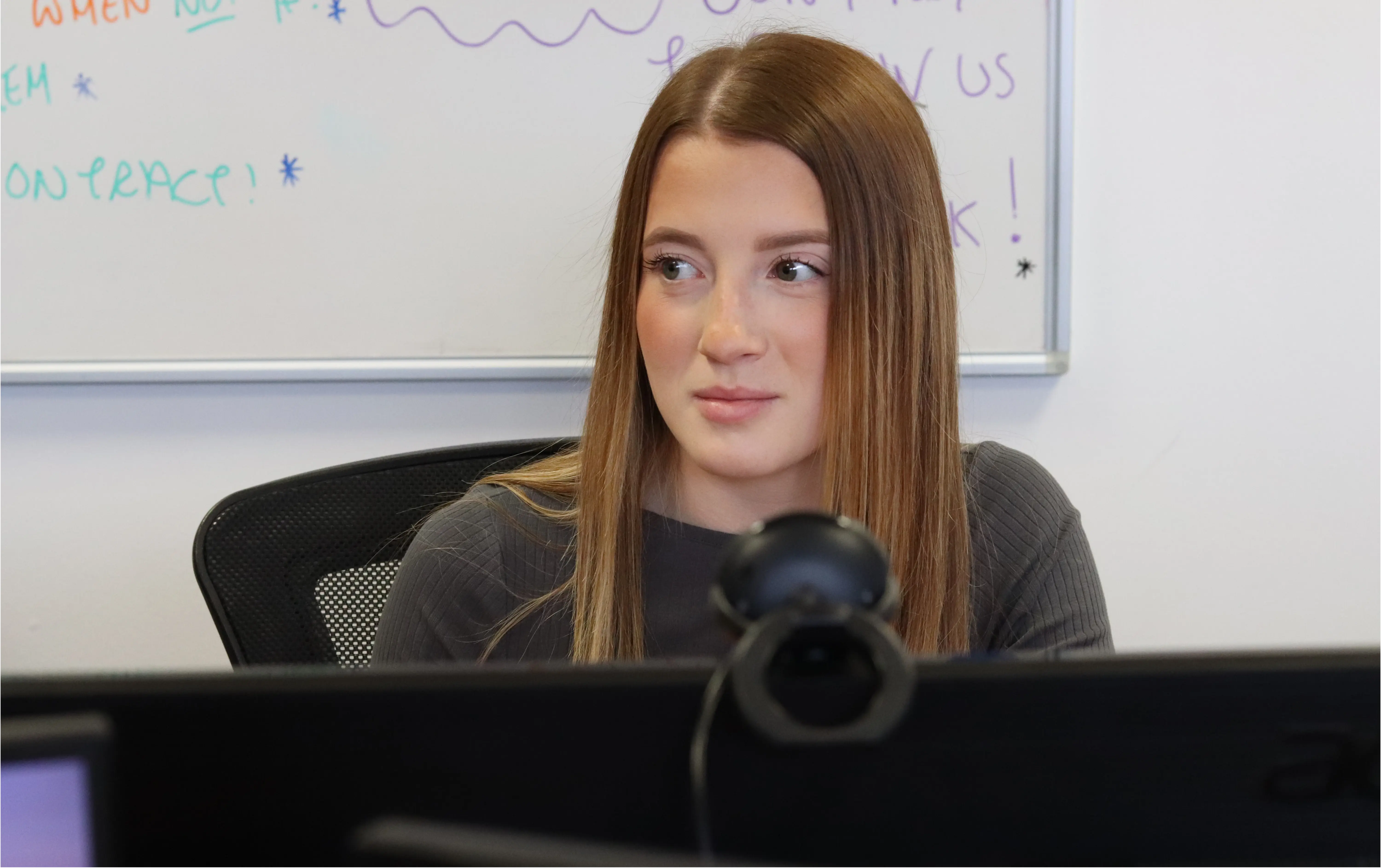 Ellie thinking about how she can best apply the new social media trends to a client's business.