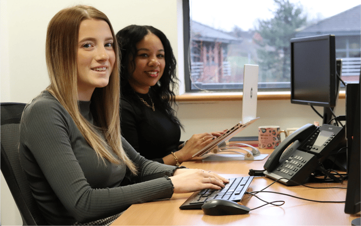 Ellie and Kerry from JDR working on digital marketing strategies in the office, representing the team helping businesses improve visibility through social and AI search.