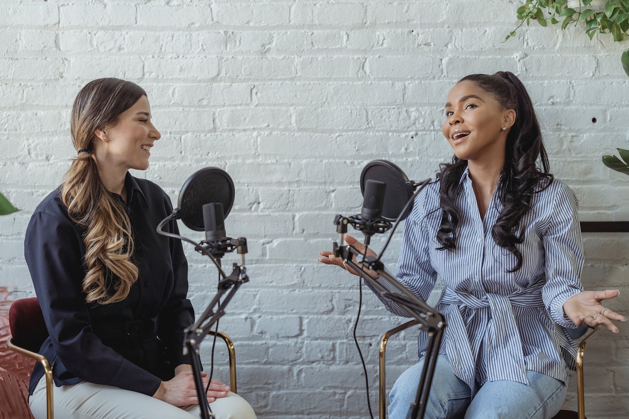 A businesswoman talking to an influencer on her podcast to help increase her business's marketing ROI