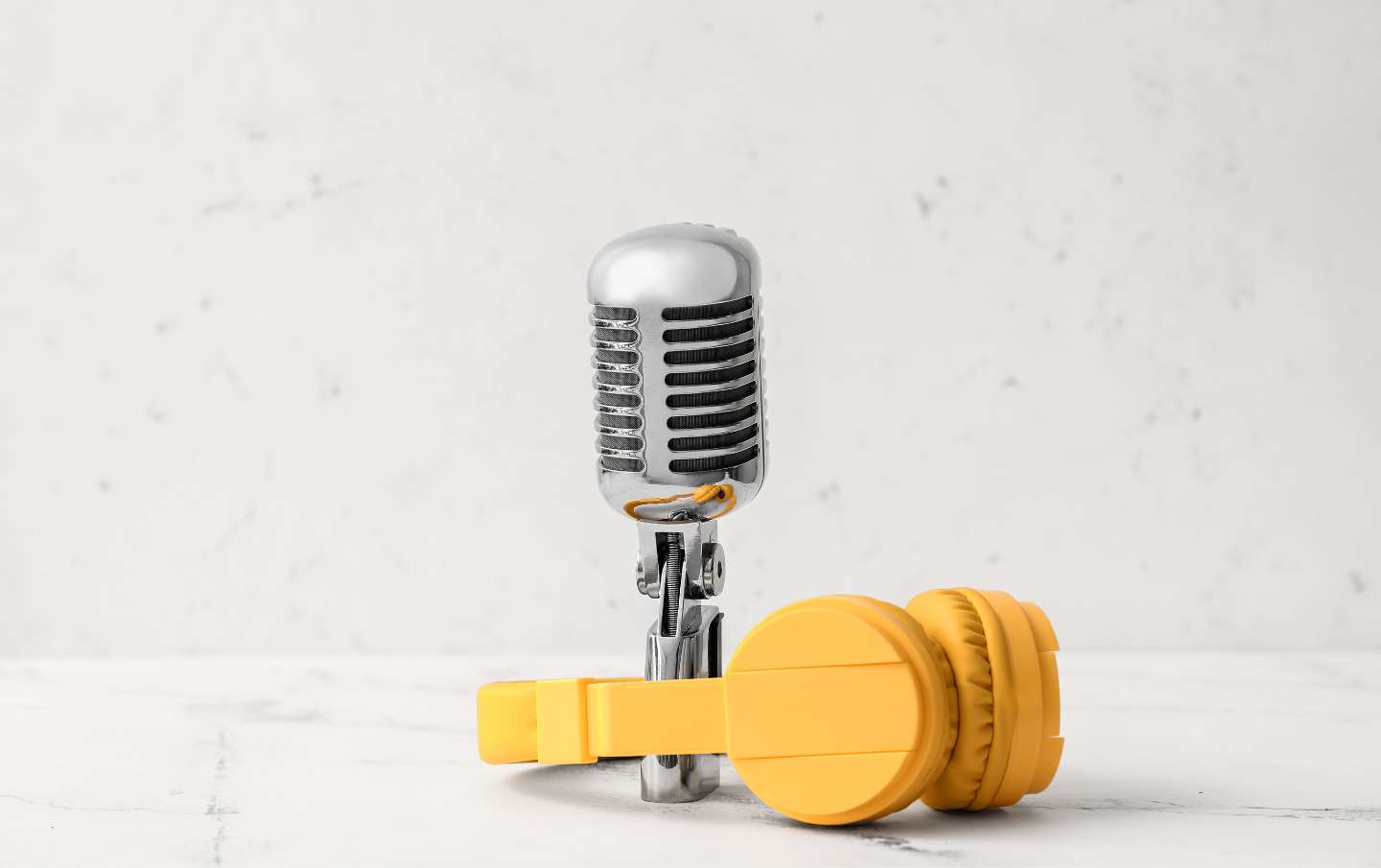 A business owners microphone with yellow headphones around it as they discover the ideal tone of voice for their content