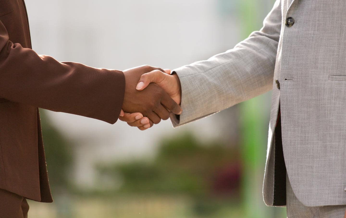 An S M E business owner and an Elite HubSpot Partner marketing agency shaking hands as they agree to partner together for the S M E's marketing practices