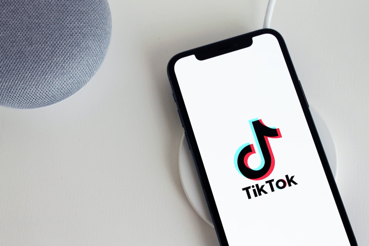 An ecommerce business owners iPhone with TikTok open on the screen as they start their TikTok marketing strategy to promote their business
