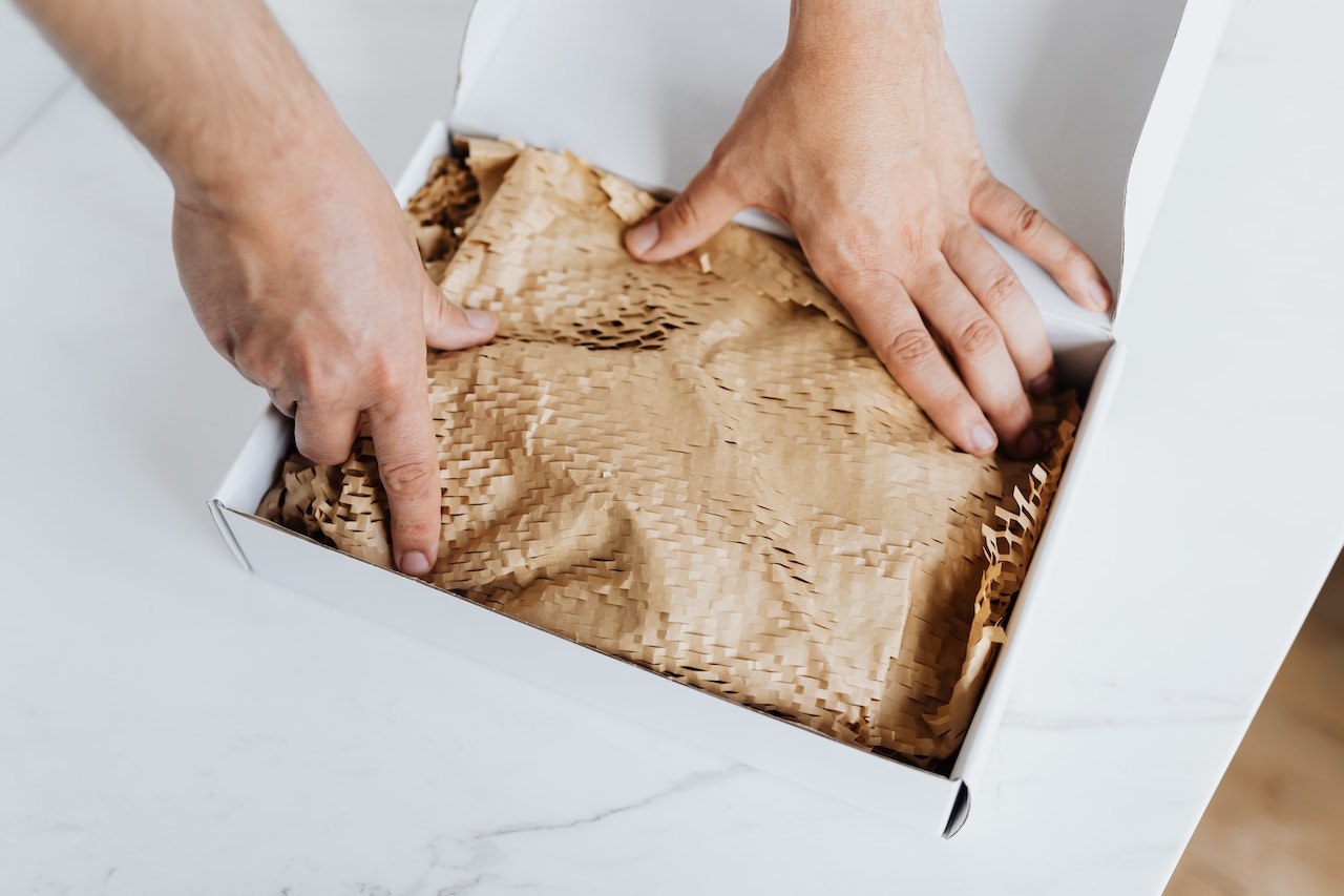 An Ecommerce businessowner packing products ready for shipping after an influx of website traffic and sales boosted from effective marketing