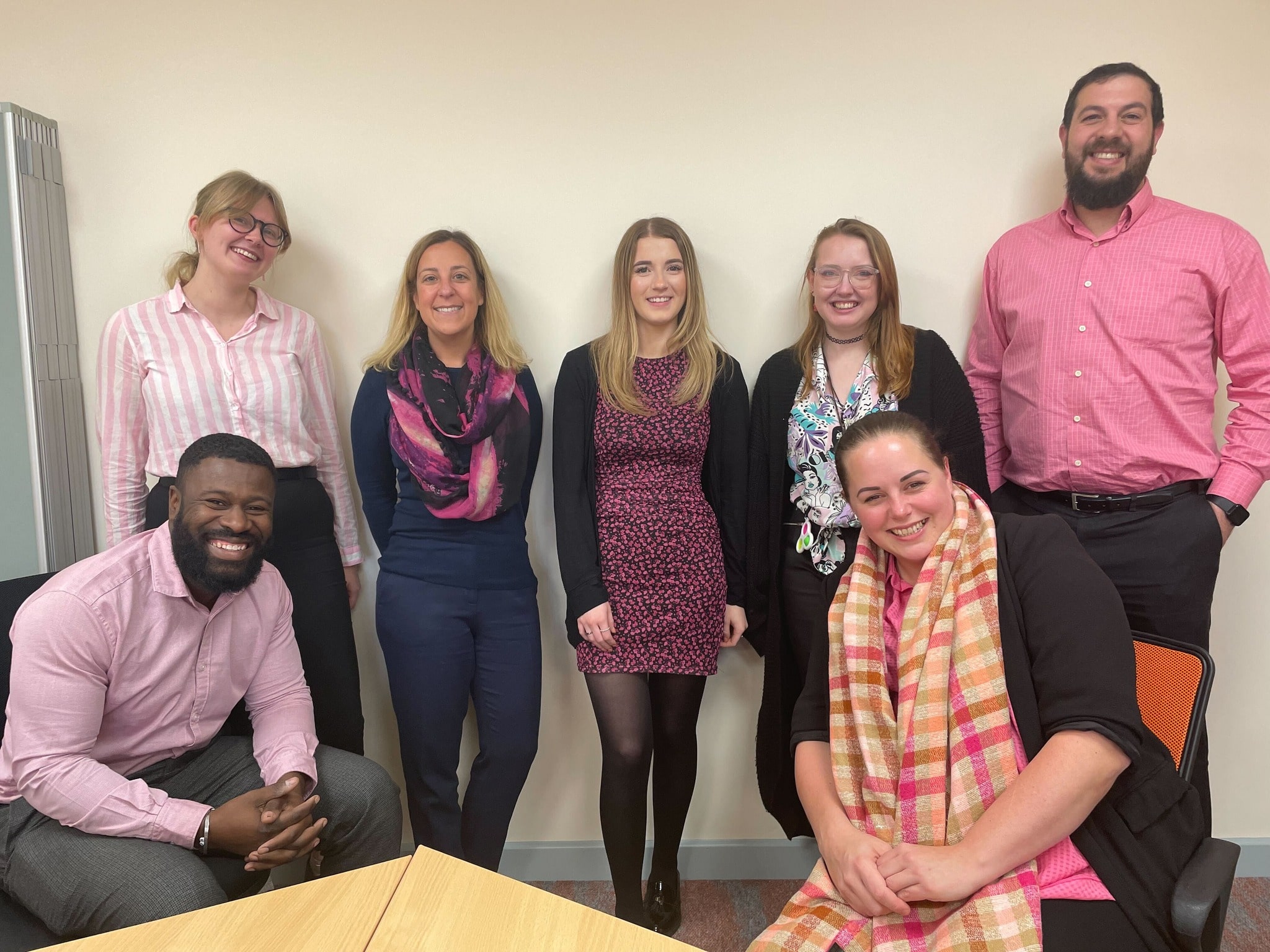 The JDR team standing together wearing pink for breast cancer awareness day and fundraising