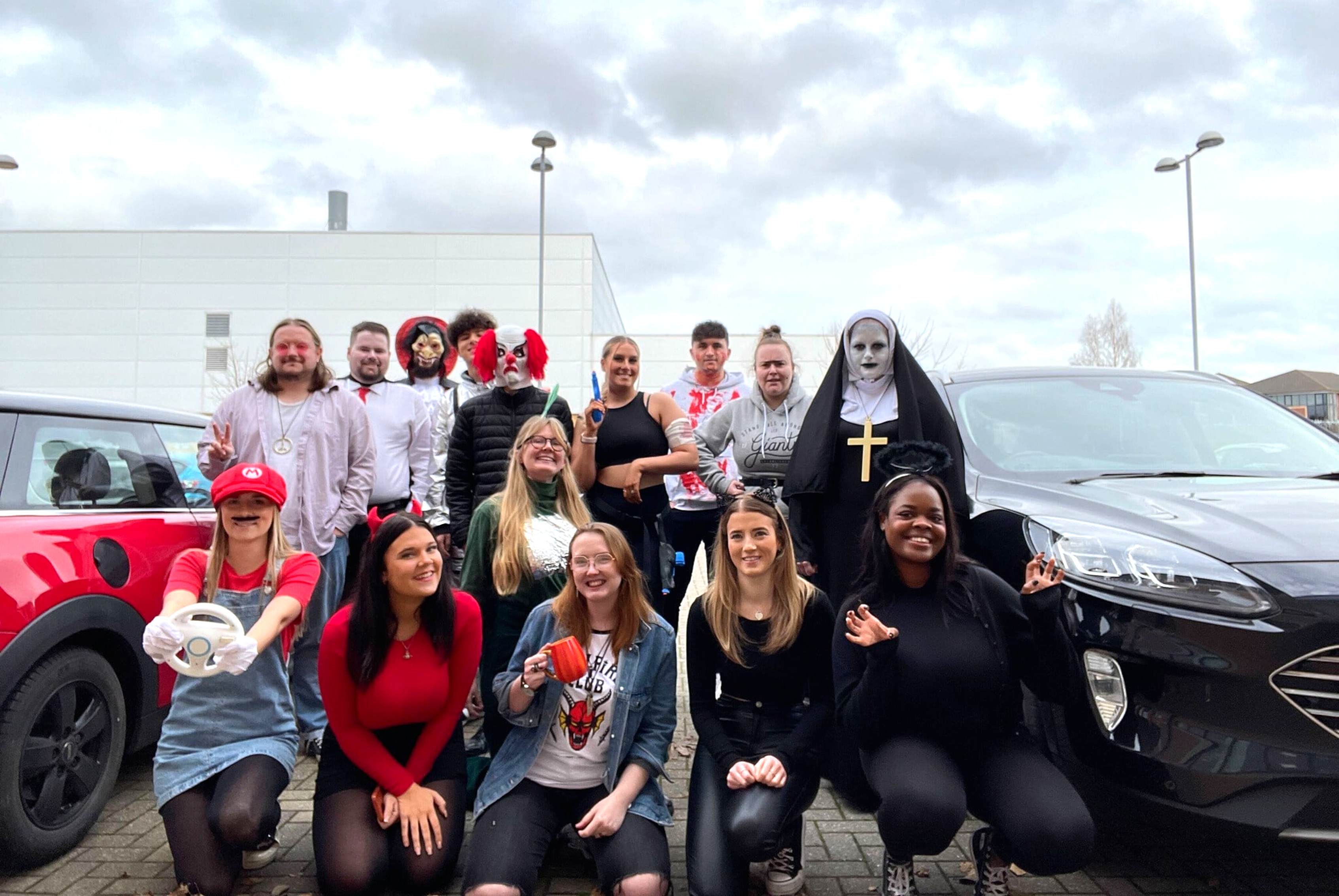 The JDR team grouped together in the car park in halloween costumes for Halloween dress up day at the office