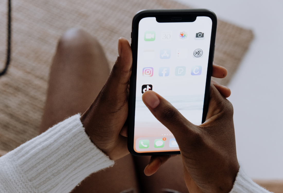 A close up of a women on here phone pressing on the tiktok app after the tiktok ban in the US.