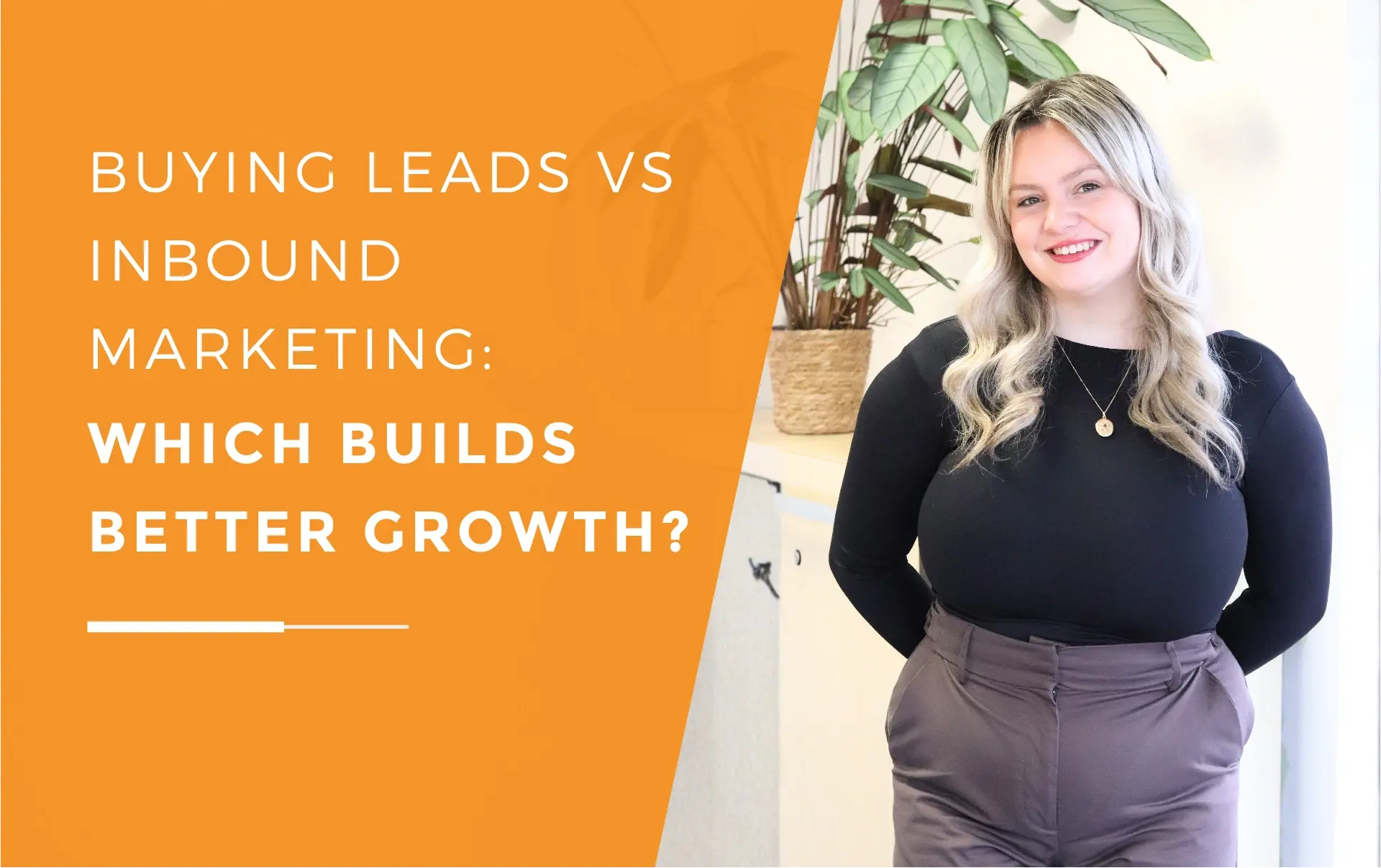 Megan standing next to a plant on top of a cupboard while smiling at the camera.