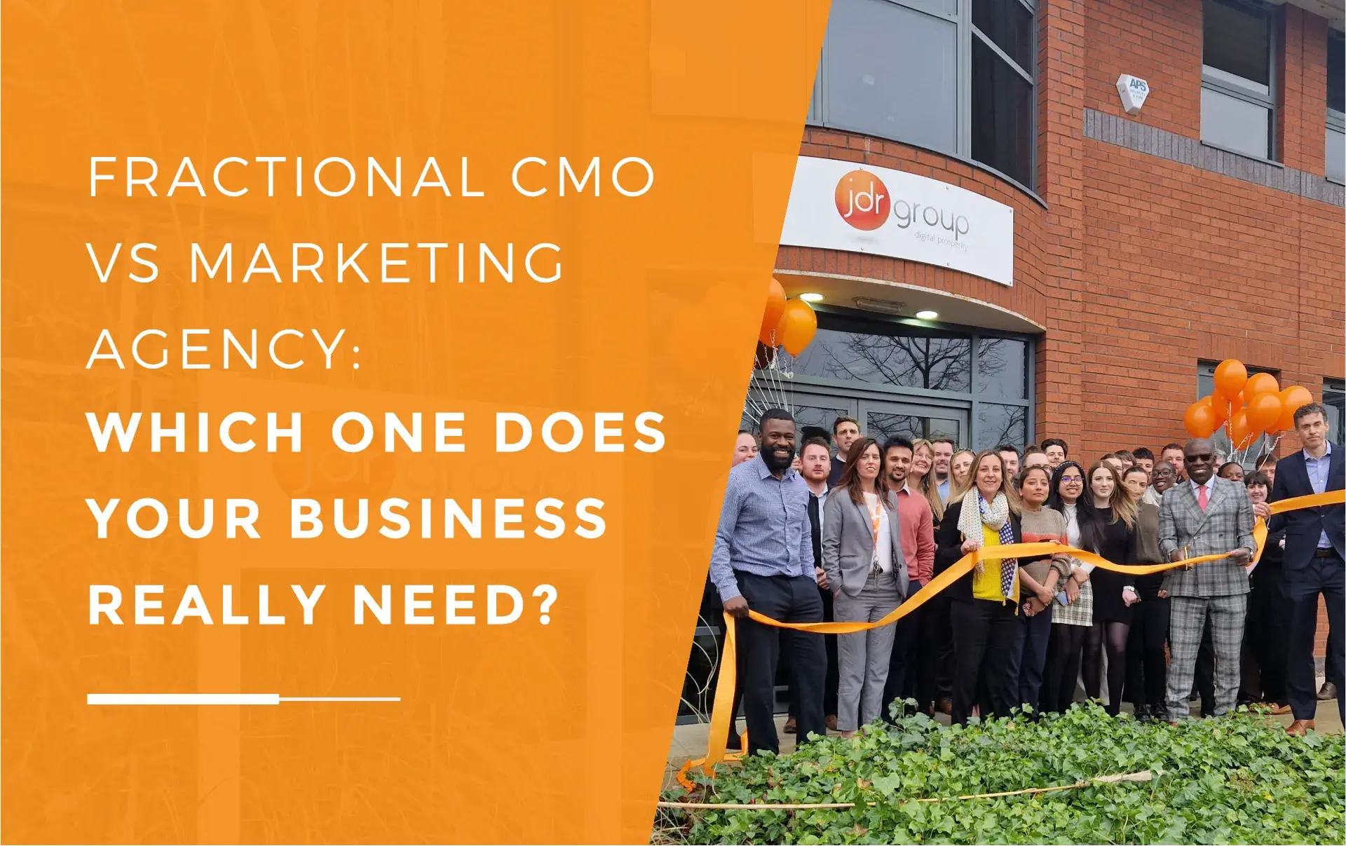 JDR Group team gathered outside their office during a ribbon-cutting ceremony, with staff holding orange balloons and smiling in front of the company signage.