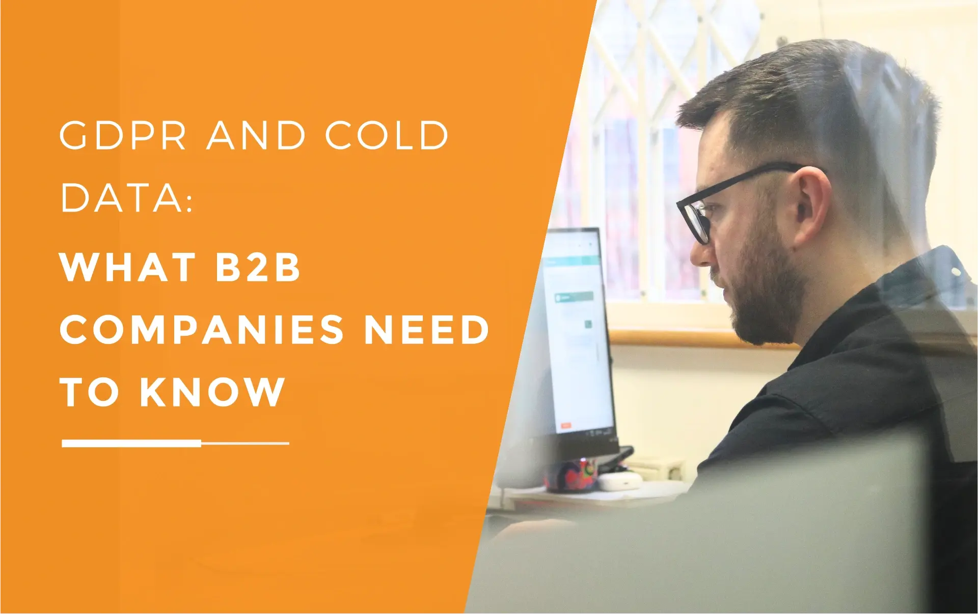 James focusing intently on his computer screen with his glasses on, researching gdpr and cold data.