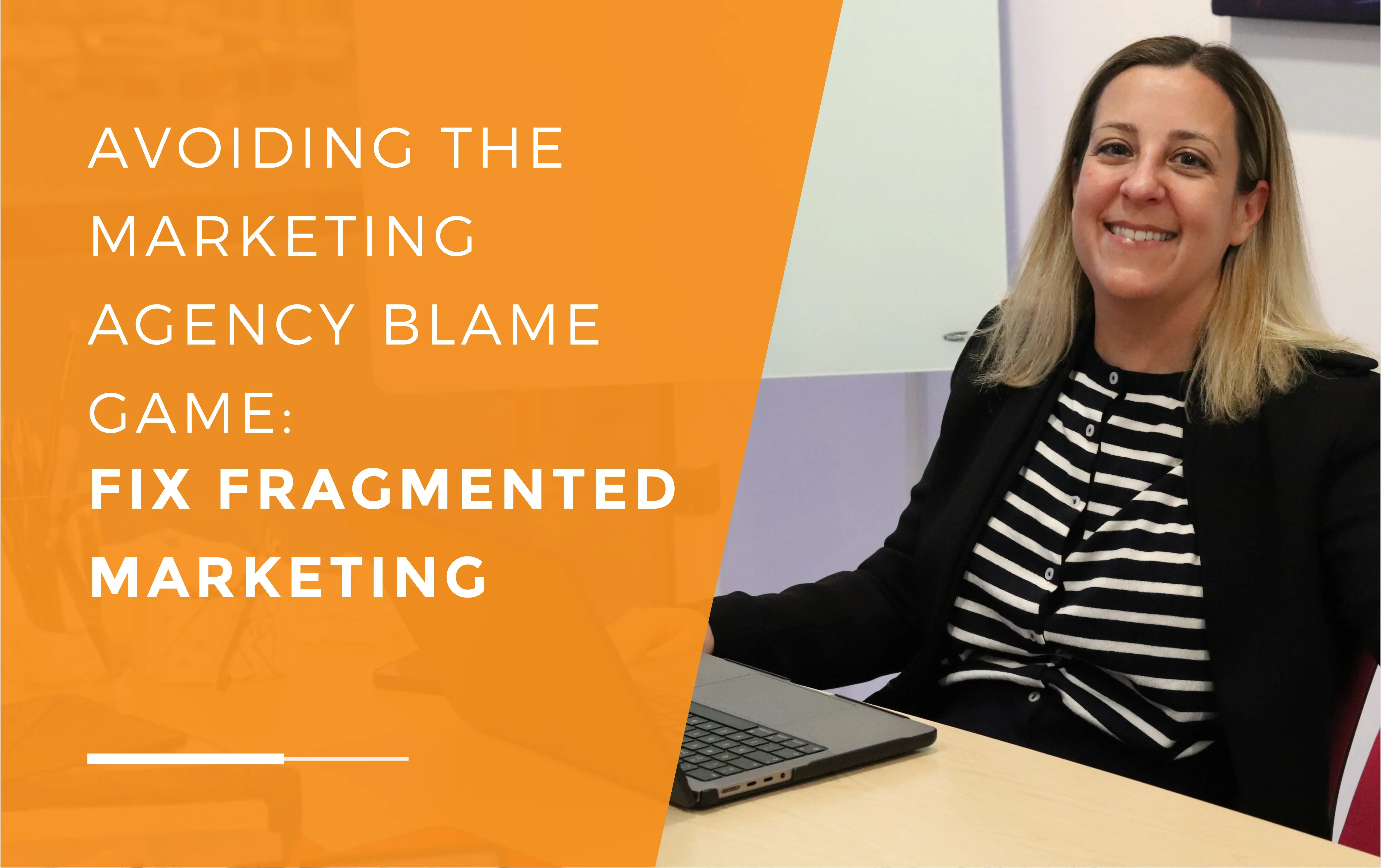 Leanne, one of our directors of JDR Group, sitting in front of a laptop at her desk, smiling.