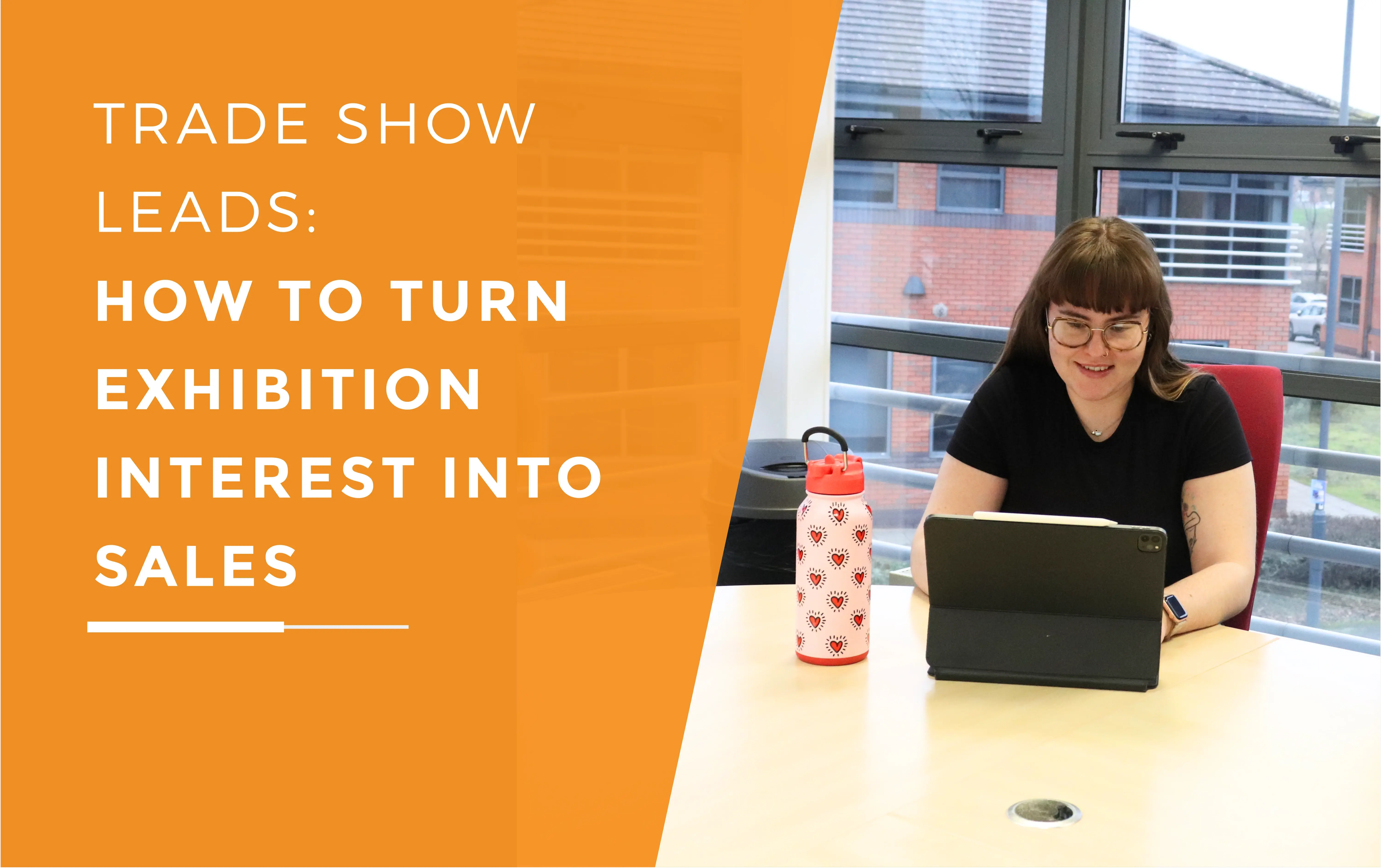 Ellis typing away on her I-pad with a waterbottle next to her.