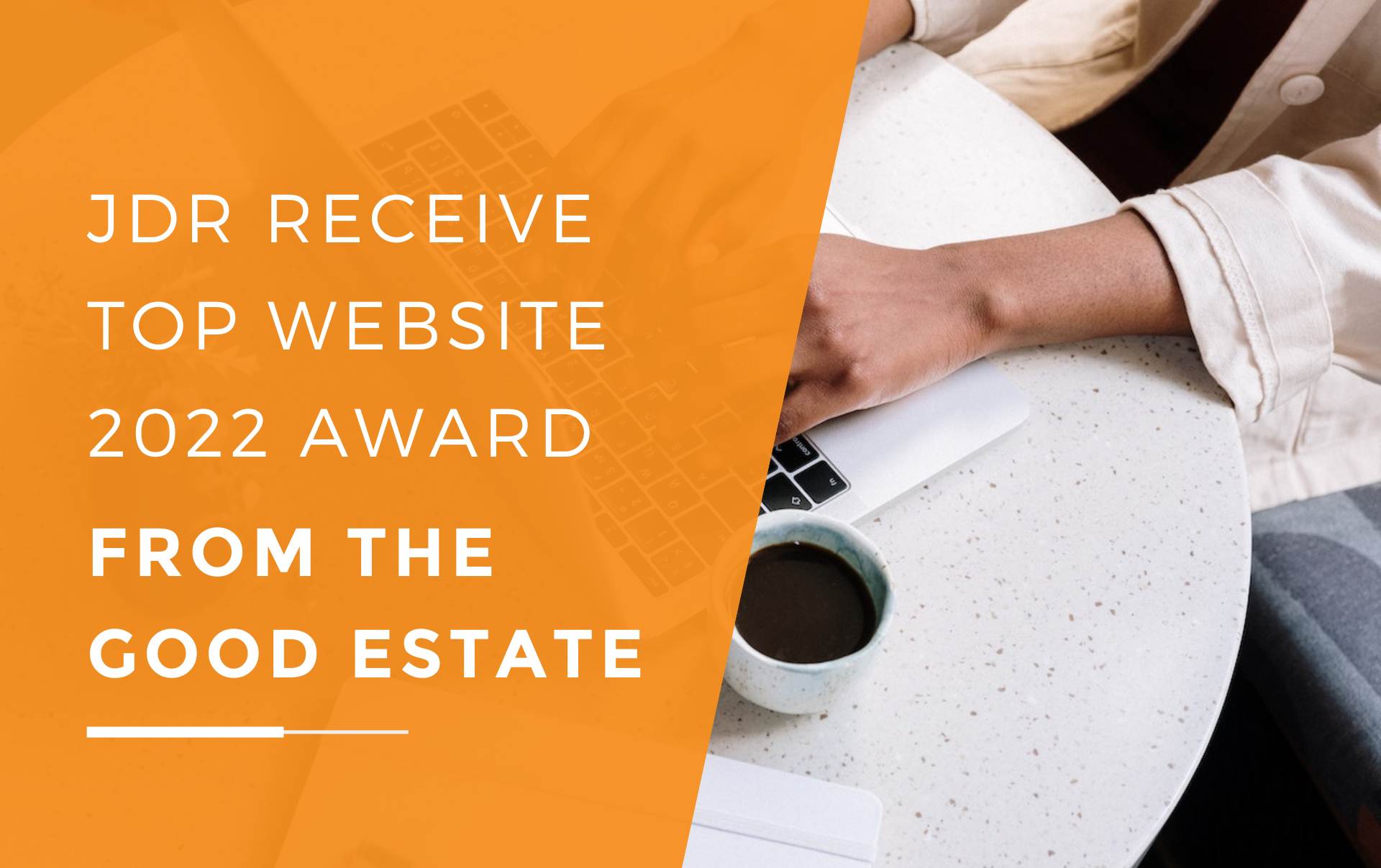 A woman sitting at a table on her laptop researching the Top Website of 2022 winner from The Good Estate with a coffee.