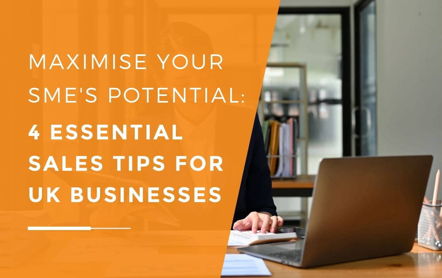 A UK business owner working on her laptop at her desk in an office while reading sales charts from a clip board after her business started following essential sales tips to help it grow.