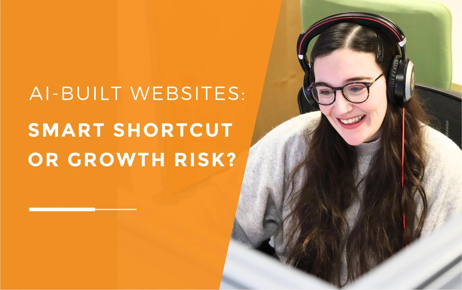 Danni wearing glasses and her hadset, smiling and looking down at her computer.