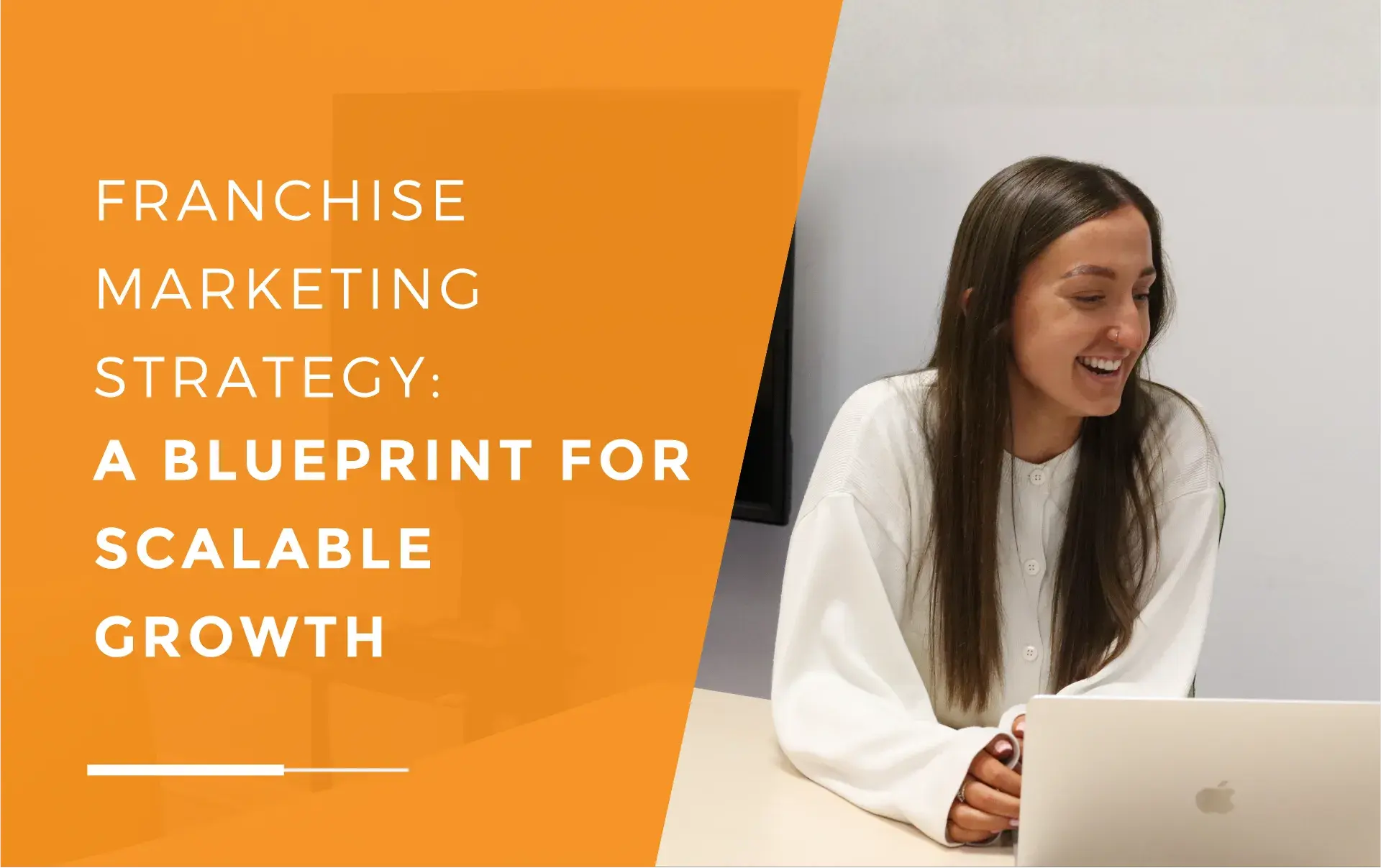 Emily laughing in a meeting with her laptop in front of her, discussing a franchise marketing strategy.