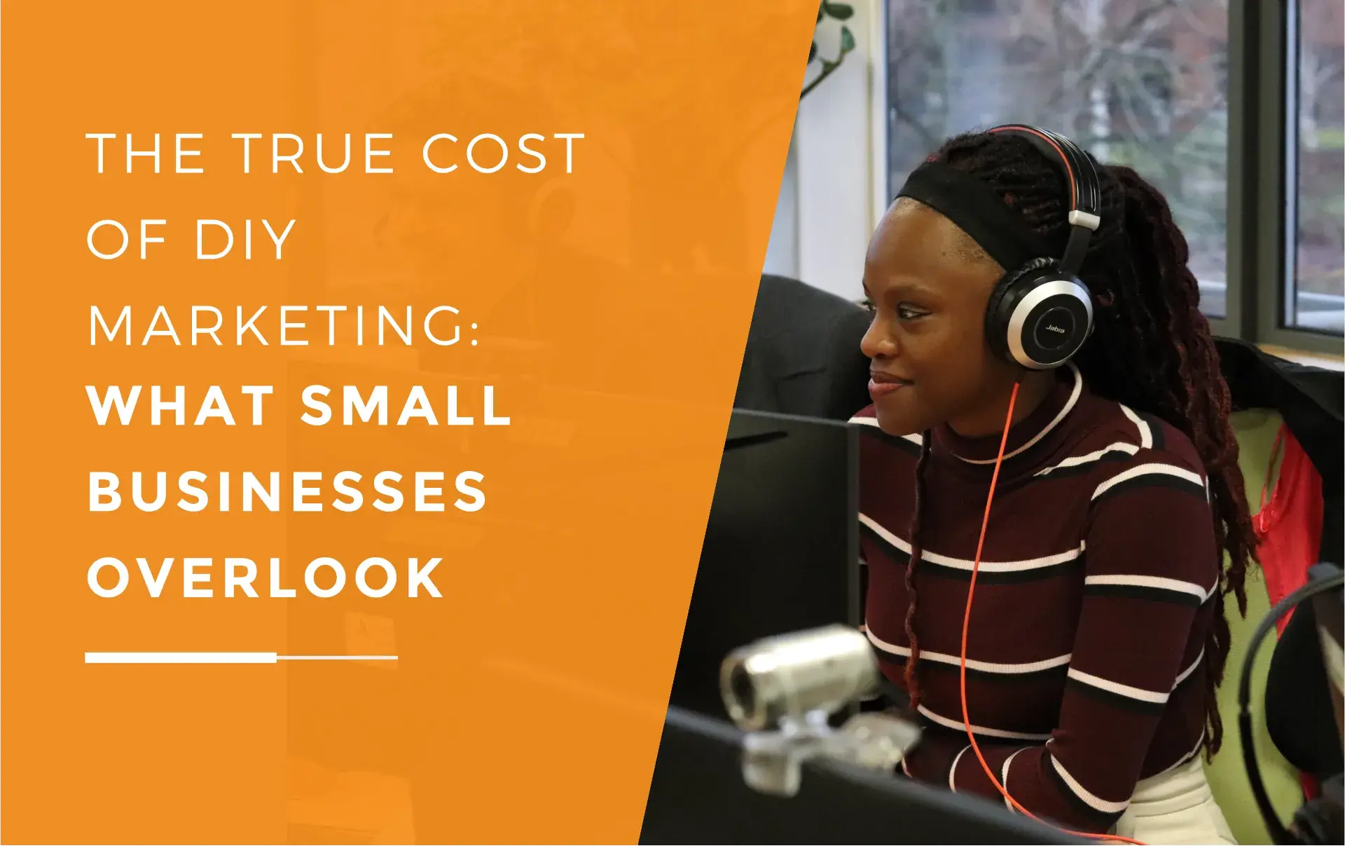 Mia at her desk with headphones on, working on content to help small businesses with their marketing.