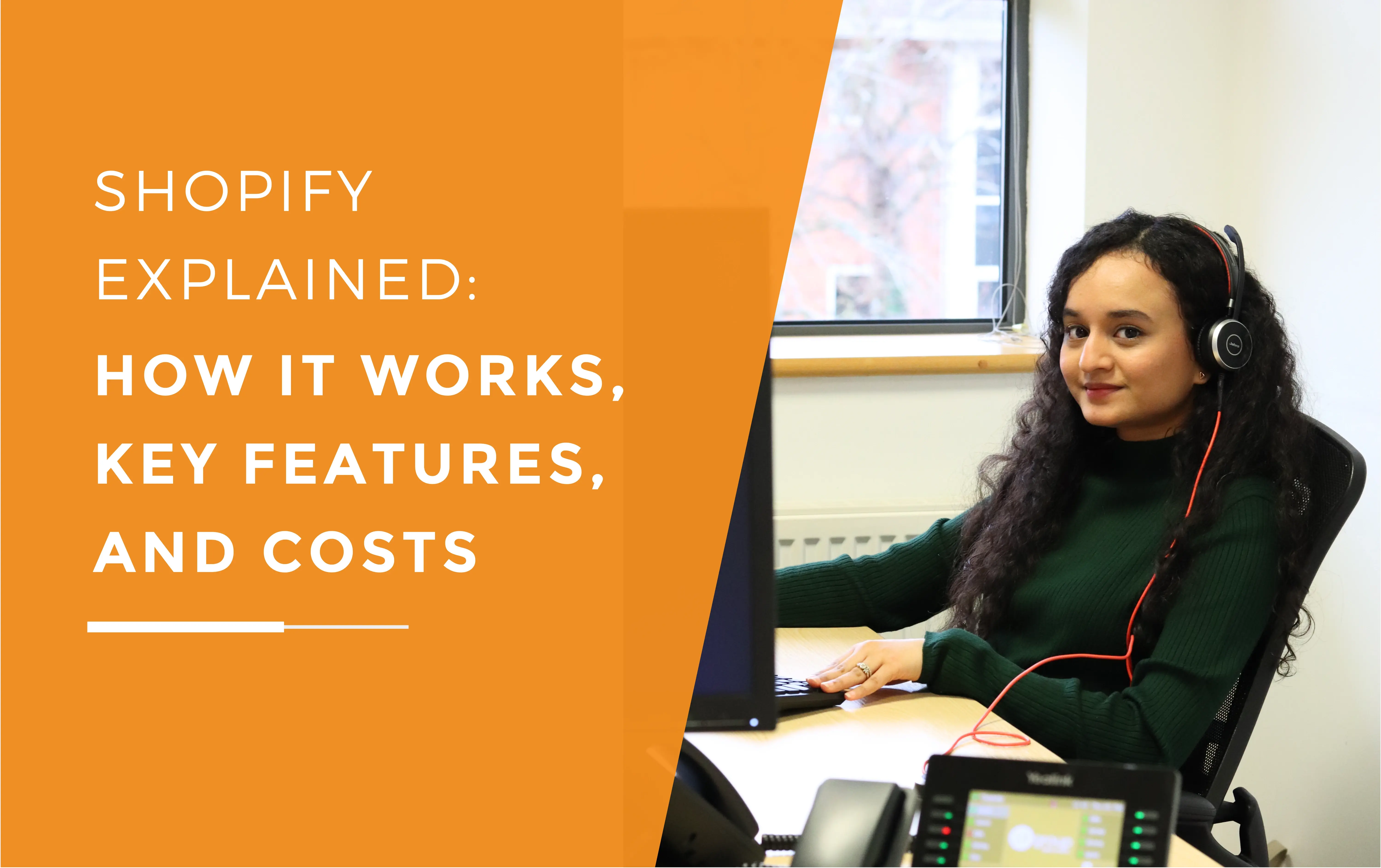 Ash smiling with her headset on at her desk reviewing a Shopify ecommerce website.