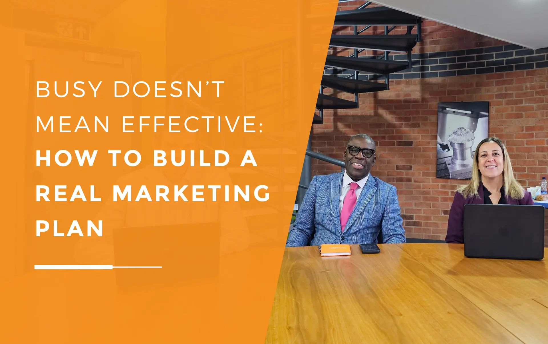 JDR Group directors and the social media manager sitting together at a meeting table with laptops, smiling during a strategy discussion.
