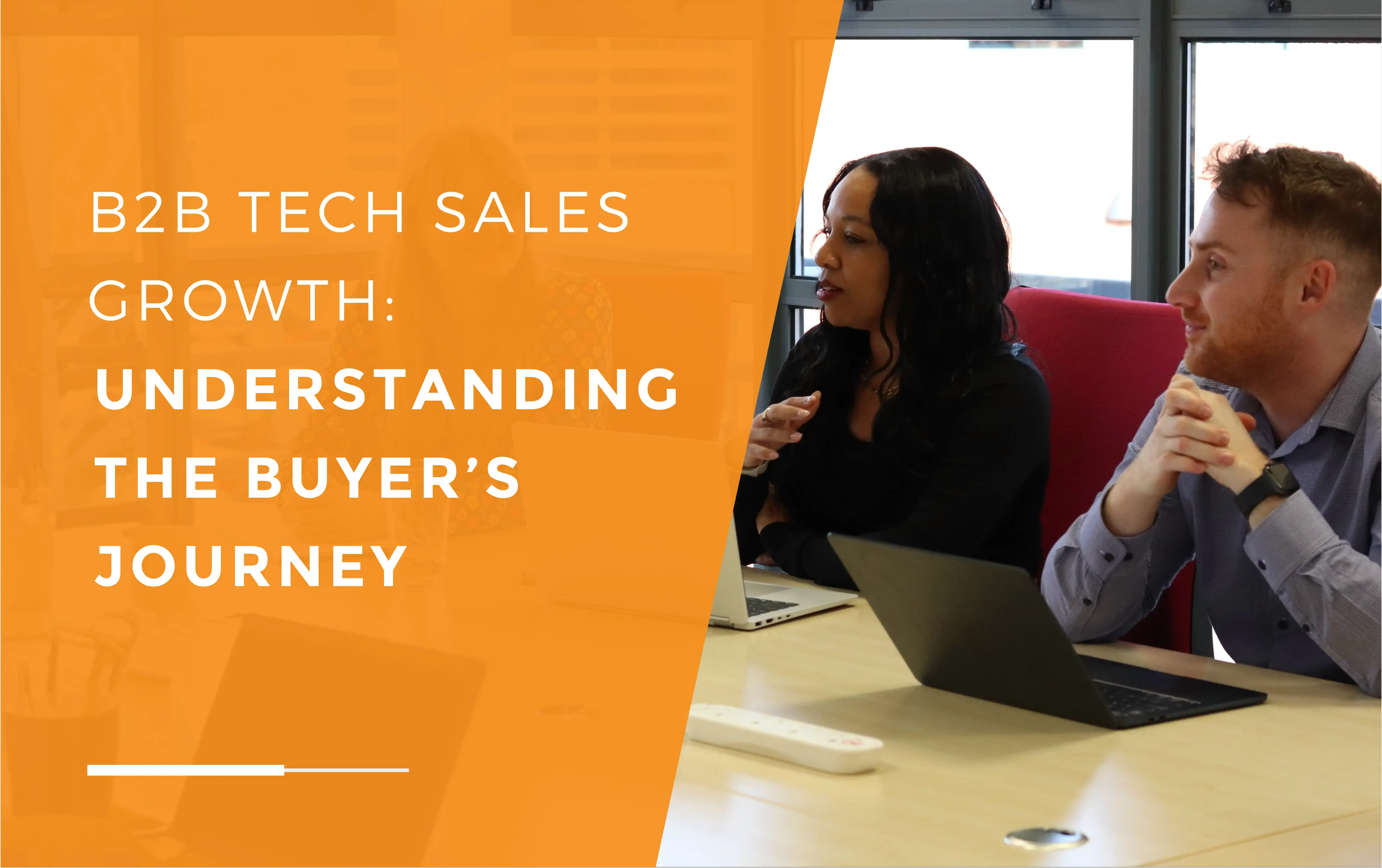 Kerry and John during a meeting with their laptops in in front of them discussing the buyer's journey.