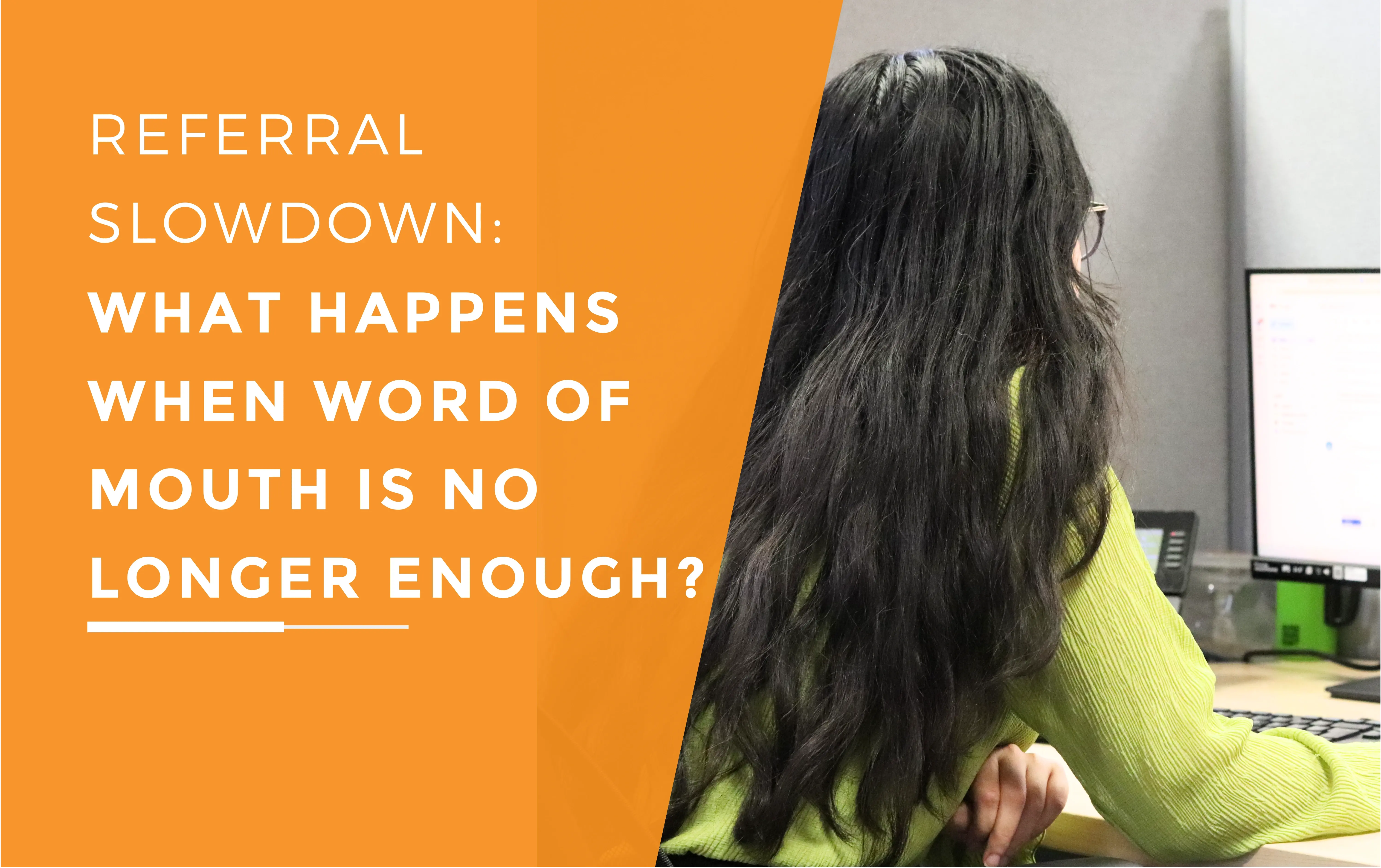 The back of Ayesha's head while she looks and types on her computer screen.
